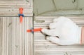 Tiler`s hand is aligning tiles. Royalty Free Stock Photo