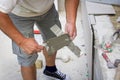 Tiler spreading glue on a tile