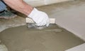 Tiler spreading tile adhesive on the floor