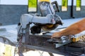 Tiler using diamond blade saw machine to cut ceramic a tile