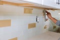 Tilers filling the space between tiles using rubber trowel grouting ceramic tiles