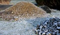 Tilers put cobblestones in sand or gravel. they have piles ready to lay or wooden pallets occupy the passage on the sidewalk