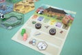 The tiles and meeples of tabletop board game Takenoko. Popular family hobby strategy board game. Minsk, Belarus - July