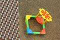 Tiles on pavement and colorful kids sand box on playground, top view