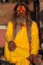 Saddhu with saffron yellow cotton long shirt, Pashupatinath temple