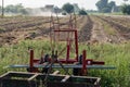 Tillage implement in the middle of the soil waiting to be used to prepare the crop