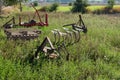 Tillage implement in the middle of the soil waiting to be used to prepare the crop