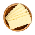 Tilsit cheese slices, sliced Tilsiter cheese, in a wooden bowl