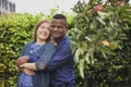 Tilst, Denmark, 12th of August: Interracial family hugging in backyard Royalty Free Stock Photo