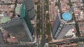 Tilt down view of multilane roads leading between downtown skyscrapers. Aerial view of tall buildings with helipads on