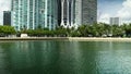 tilt footage of the rippling green water at Maurice A. Ferre Park and high ridge luxury condos and hotels and One Thousand Museum