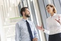 Tilt image of business people discussing while standing at office