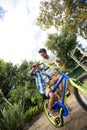 Tilt image of father assisting son for riding bicycle