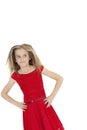 Tilt image of girl wearing red frock looking sideways with hands on hips over white background Royalty Free Stock Photo