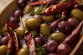 Tilt image of olives with red chili pepper