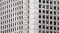 Tilt shot of modern high-rise office building with a glass facade.