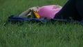 Tilt shot of woman laying on a blanket fondling a bouquet of flowers