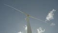 Wind turbine from below as IT rotates during the day time