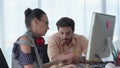 Tilt-up video shot of Business partners sitting and discussing in office