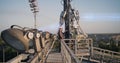 Male technicians fixing transmitting antenna