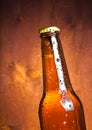 Tilted bottle of fresh beer with drops Royalty Free Stock Photo