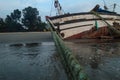 Tilted fishing boat lying on beach