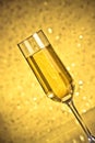 Tilted flute of golden champagne