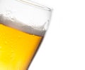 Tilted glass of beer and drops on white background Royalty Free Stock Photo