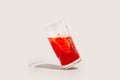 A tilted glass of red vermouth