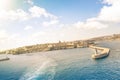 Tilted horizon view of La Valletta before sunset from the sea