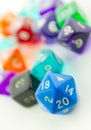 Tilted macro of blue twenty sided dice with other dice Royalty Free Stock Photo