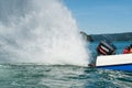 Tilted up outboard enginge creating a big spray.. Royalty Free Stock Photo