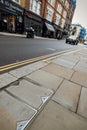 Tilted view of city street with double yellow lines and blurred background