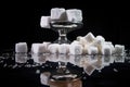 tilted view of a dumbbell with a heap of sugar cubes on a reflective surface