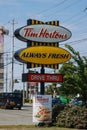 Tim Hortons drive through banner and sign next to restaurant. Canada\'s quick serve restaurant chain Royalty Free Stock Photo