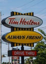 Tim Hortons drive through banner and sign next to restaurant. Canada\'s quick serve restaurant chain