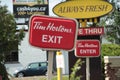 tor, canada - July 21, 2023: tim hortons exit enter drive thru signs one in front of the other with cars. phot