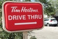 tor, canada - July 21, 2023: tim hortons rectangle drive thru sign top left corner with car vehicle. phot