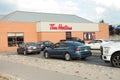 tor, canada - august 10, 2023: tim hortons restaurant coffee shop drive thru packed with cars vehicles summer. p