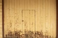 Timber door background with weathered yellow paint