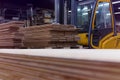 Timber Flooring Factory. Pile of cut wood in factory storage warehouse. Lumber in warehouse Royalty Free Stock Photo