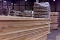 Timber Flooring Factory. Pile of cut wood in factory storage warehouse. Lumber in warehouse