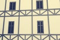 Timber framed facade of old building with wooden windows. Royalty Free Stock Photo