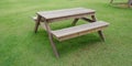 Timber garden table on green glass