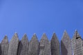 Timber pickets against blue sky