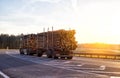 Timber truck with a trailer to transport long timber logs along the motorway. Timber transportation, industrial Royalty Free Stock Photo