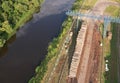 Timber truck unloading a cut trees in at woodworking plant. Transportation raw timber from felling site. Gantry crane loads logs Royalty Free Stock Photo