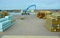 Timber yard dockside with grabber Royalty Free Stock Photo