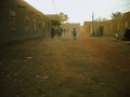 Timbuktu, Mali, Africa - February 2, 2008: Man walking behind the market through the sand