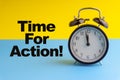 TIME FOR ACTION inscription written on Alarm Clock on blue yellow background Royalty Free Stock Photo